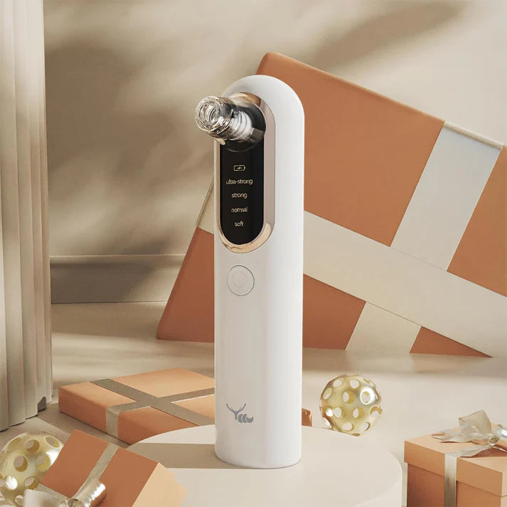 Glinterra – Professioneller Hautreinigungs- und Porensauger auf einem Tisch mit Geschenkverpackungen.